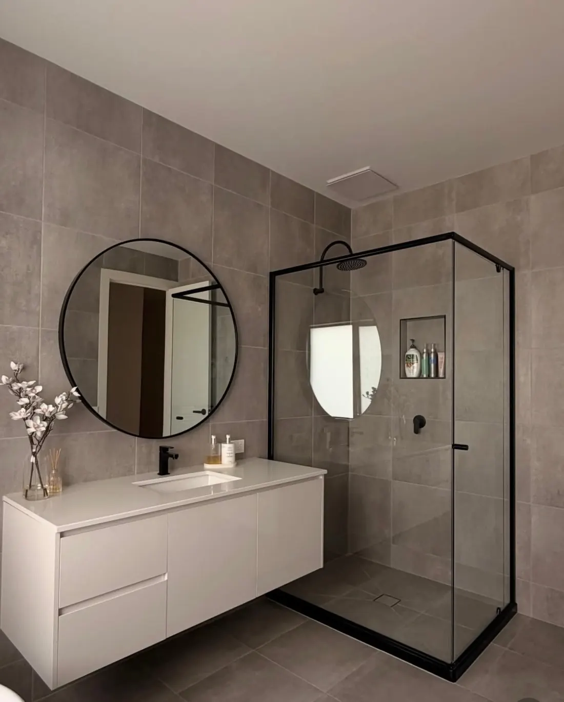 A spotless modern bathroom cleaned by Lather & Mop Co.