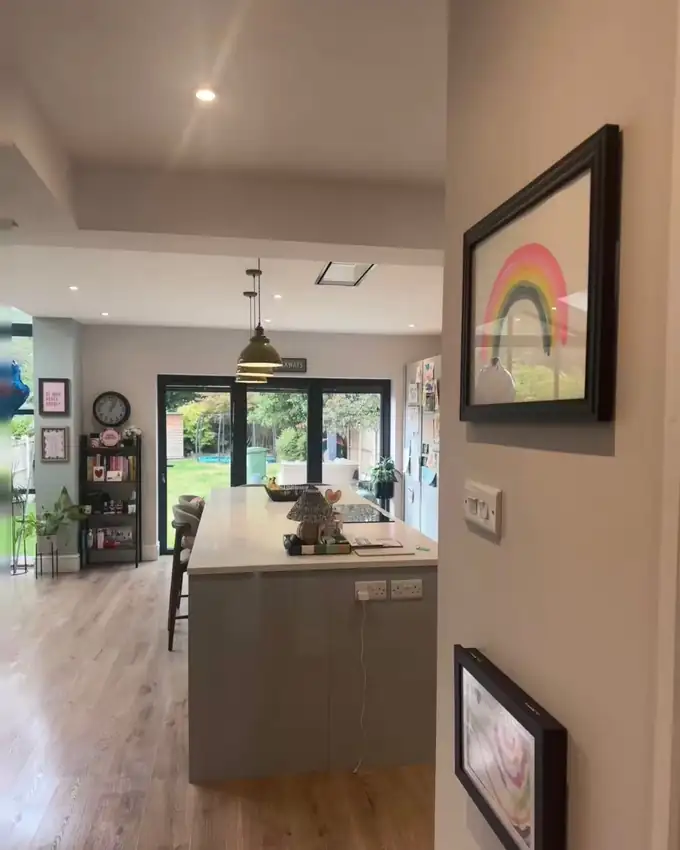 An open plan kitchen and living space with clean floors and clear surfaces